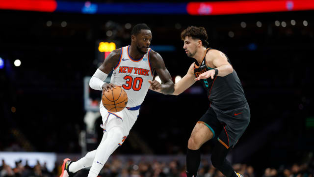 Nov 17, 2023; Washington, District of Columbia, USA; New York Knicks forward Julius Randle (30) drives to the basket as Washington Wizards forward Deni Avdija (8) defends in the second quarter at Capital One Arena.